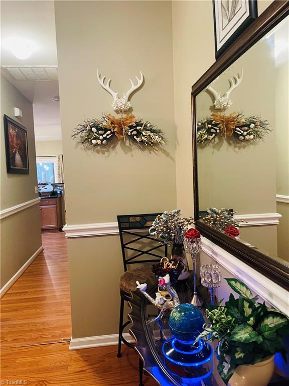 hallway with hardwood / wood-style flooring