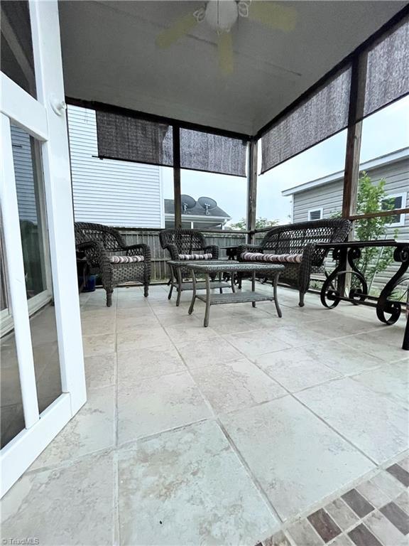 sunroom / solarium featuring ceiling fan