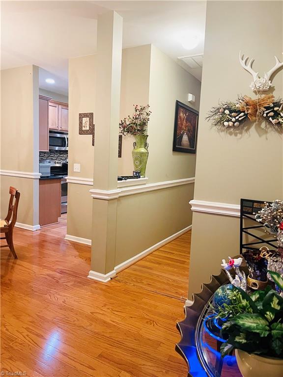 corridor with light hardwood / wood-style flooring