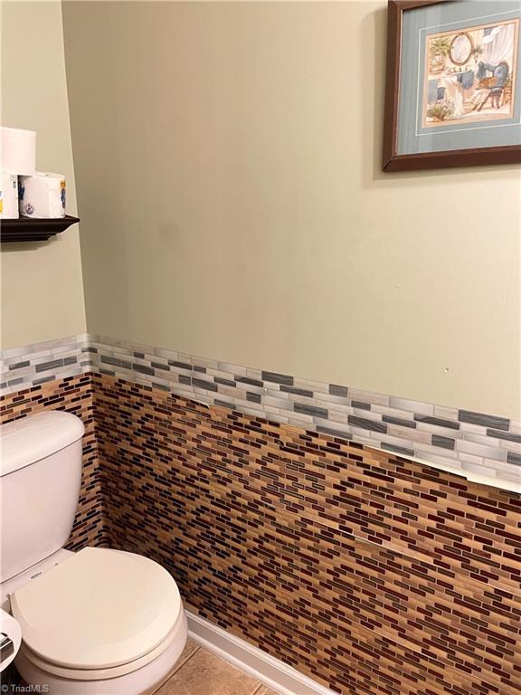 bathroom featuring tile patterned flooring and toilet