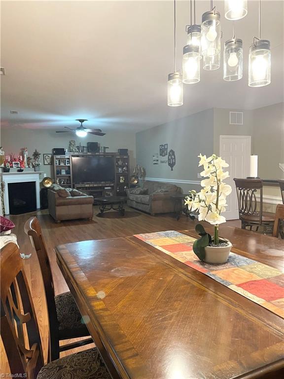 dining room with hardwood / wood-style floors and ceiling fan