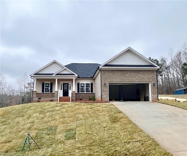 view of front facade featuring a front yard, driveway, a garage, crawl space, and brick siding