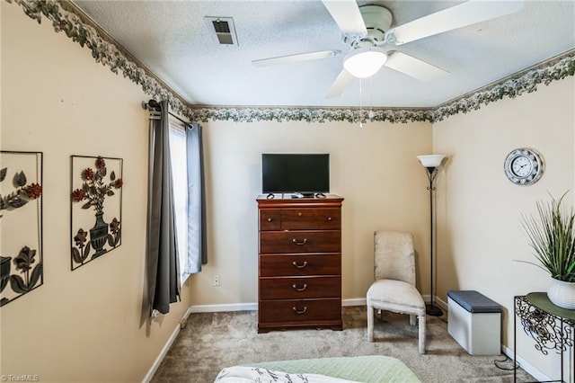 sitting room featuring a textured ceiling, light colored carpet, and ceiling fan