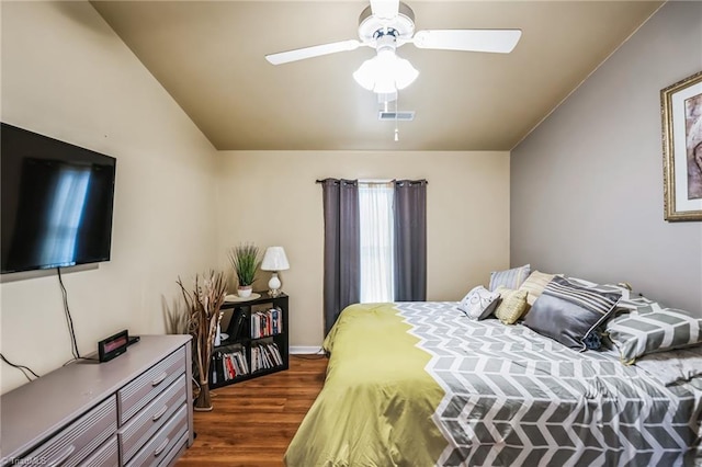 bedroom featuring ceiling fan, dark hardwood / wood-style floors, and vaulted ceiling