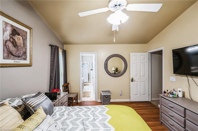 bedroom with ceiling fan, vaulted ceiling, dark hardwood / wood-style flooring, and ensuite bath