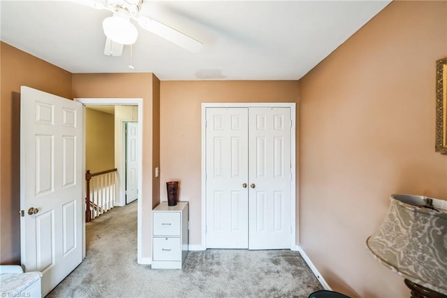 bedroom featuring light carpet, a closet, and ceiling fan