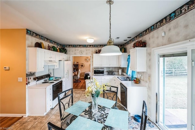 kitchen featuring white appliances, sink, decorative light fixtures, light tile patterned flooring, and white cabinetry