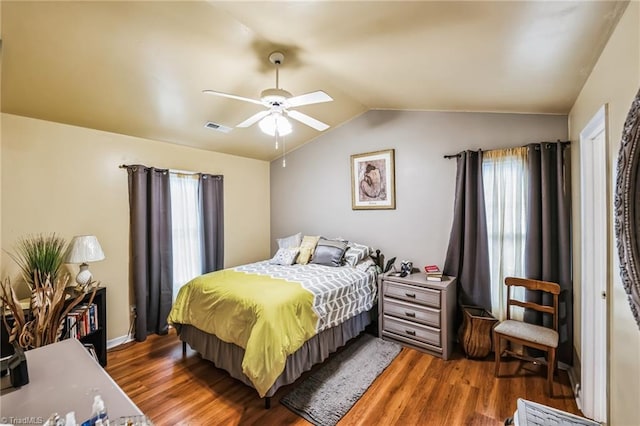 bedroom featuring ceiling fan, dark hardwood / wood-style flooring, and lofted ceiling