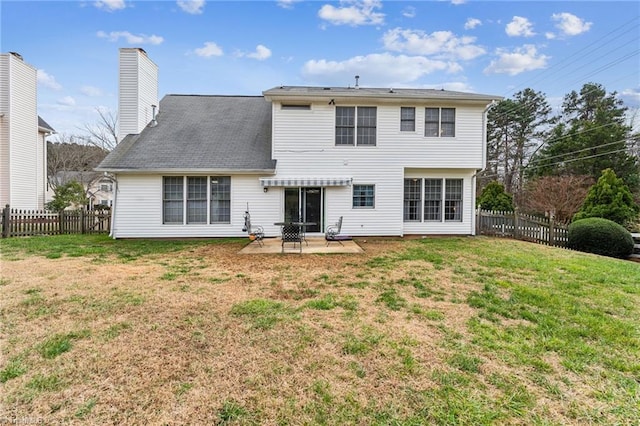 back of house featuring a patio area and a yard