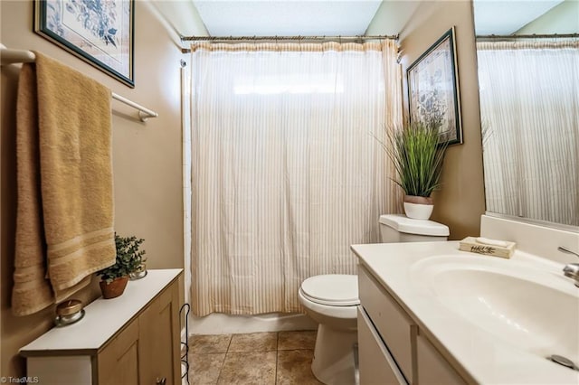 bathroom featuring tile patterned flooring, vanity, and toilet