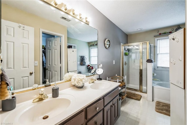 bathroom featuring vanity, separate shower and tub, and plenty of natural light