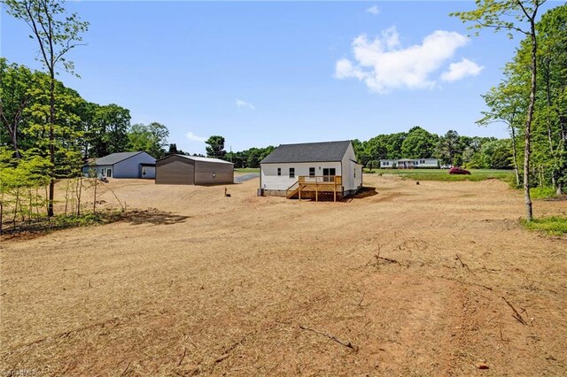 view of yard with an outdoor structure and a deck