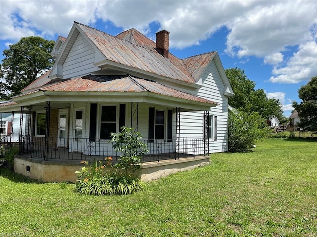 705 Washington St, Graham, NC 27253 - view of side of home with a porch, a lawn, metal roof, and a chimney