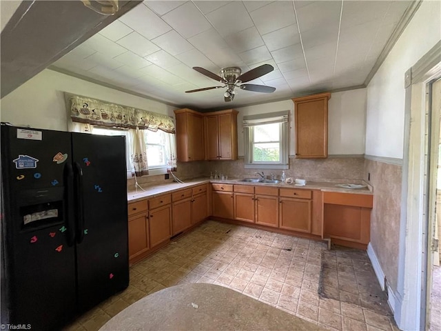 705 Washington St, Graham, NC 27253 - kitchen with black fridge with ice dispenser, a sink, a ceiling fan, and light countertops