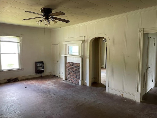 705 Washington St, Graham, NC 27253 - unfurnished living room featuring heating unit, arched walkways, ceiling fan, and crown molding