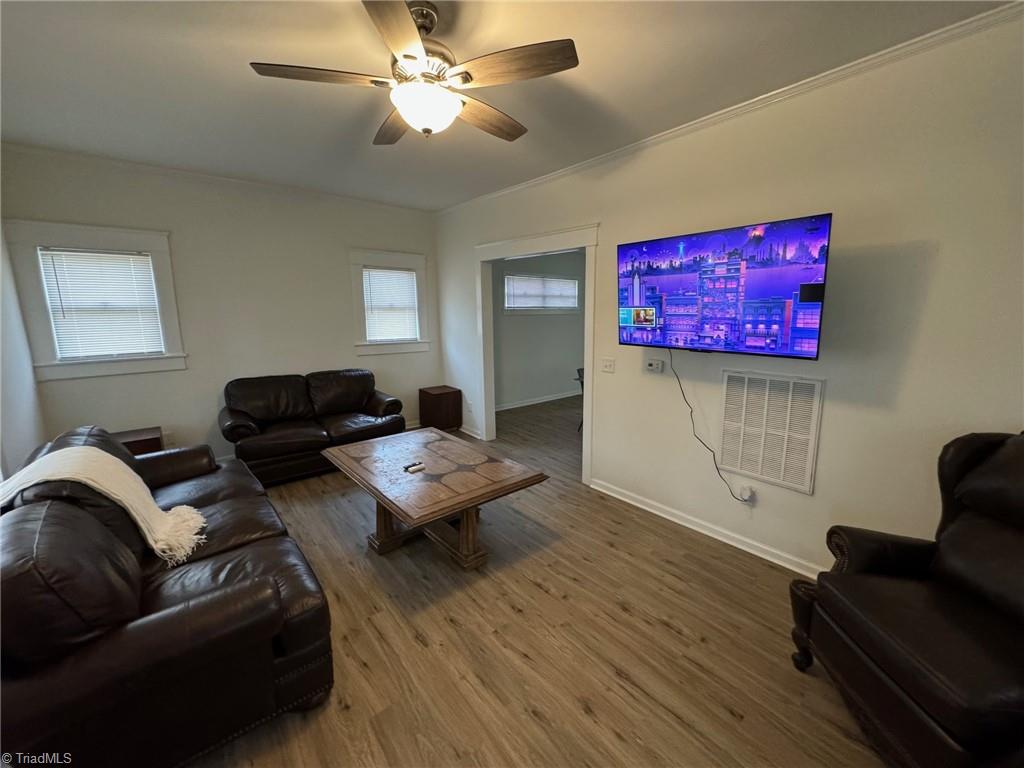 living room with ceiling fan and hardwood / wood-style flooring