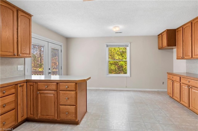 kitchen featuring kitchen peninsula and a textured ceiling