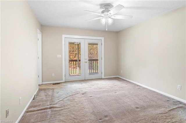 spare room with carpet flooring, french doors, and ceiling fan