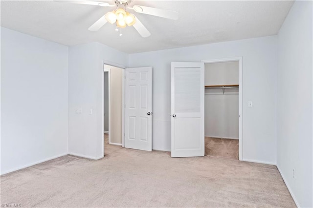 unfurnished bedroom featuring a closet, light colored carpet, and ceiling fan