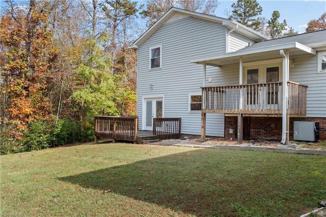 back of house with a deck, a lawn, cooling unit, and french doors