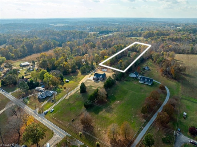 birds eye view of property with a rural view