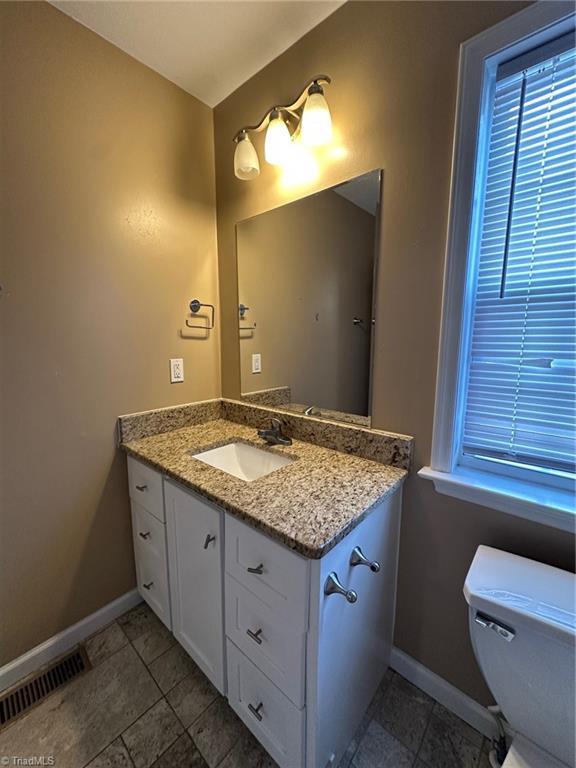 bathroom with vanity and toilet