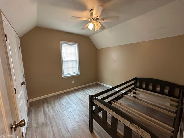 bedroom featuring vaulted ceiling, ceiling fan, and light hardwood / wood-style floors