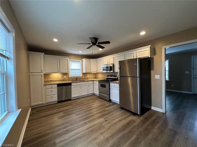 kitchen featuring white cabinetry, stainless steel appliances, dark hardwood / wood-style floors, and sink