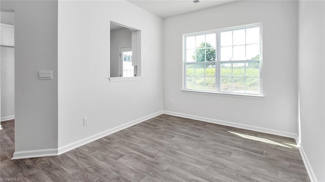 unfurnished room with hardwood / wood-style floors