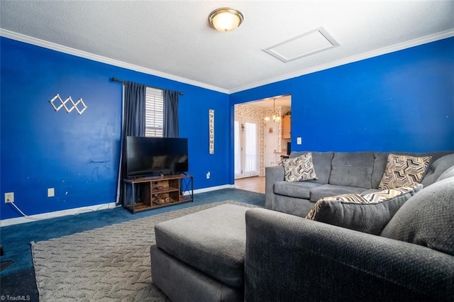 living room featuring a textured ceiling, baseboards, ornamental molding, carpet, and attic access