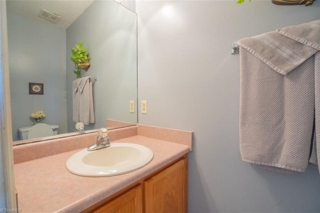 bathroom featuring visible vents and vanity