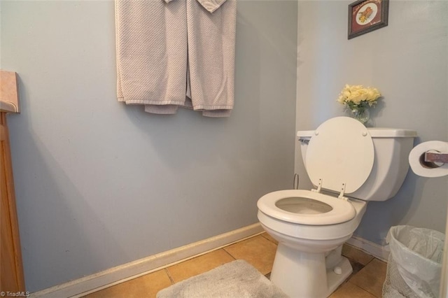 bathroom featuring tile patterned flooring, toilet, and baseboards