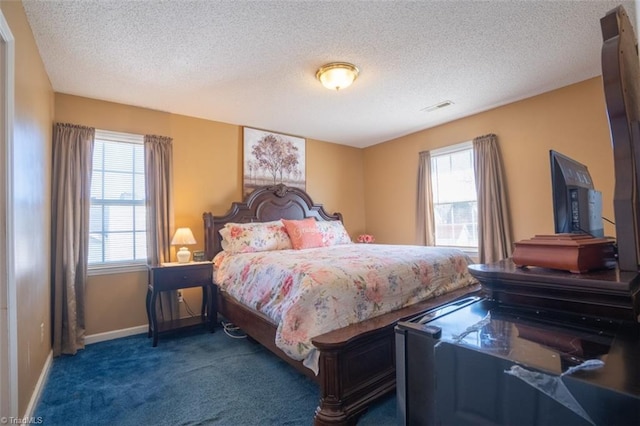 bedroom with carpet floors, multiple windows, visible vents, and baseboards