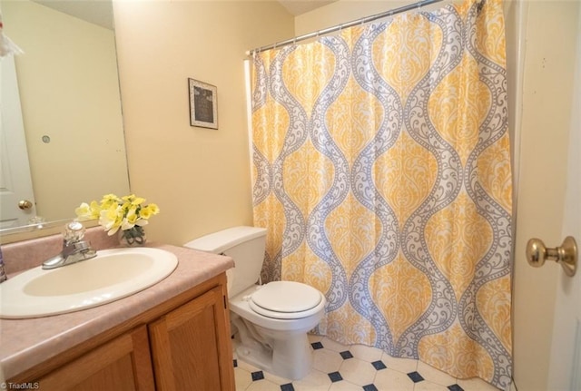 bathroom featuring toilet, a shower with curtain, and vanity