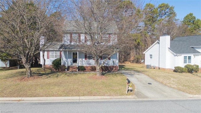 view of front facade with a porch, a front yard, and central air condition unit