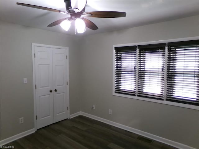 1074 Hickory Glen Rd, Winston-Salem, NC 27106 - unfurnished bedroom featuring wood finished floors, a closet, baseboards, and ceiling fan