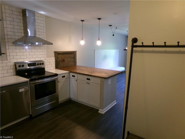 1074 Hickory Glen Rd, Winston-Salem, NC 27106 - kitchen with wall chimney range hood, appliances with stainless steel finishes, backsplash, a peninsula, and dark wood-type flooring