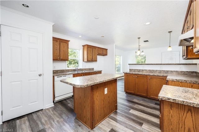 kitchen featuring white dishwasher, a center island, dark hardwood / wood-style floors, and decorative light fixtures