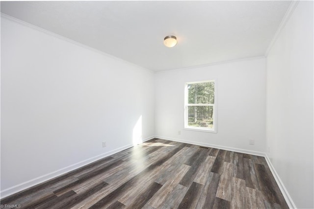 unfurnished room featuring crown molding and dark wood-type flooring