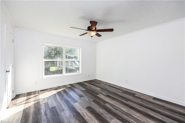 spare room with ceiling fan, ornamental molding, a textured ceiling, and dark wood-type flooring