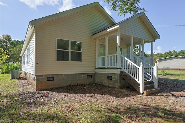 view of front of house featuring a porch and central AC