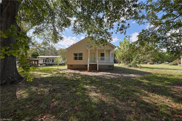 back of house with a yard and a porch