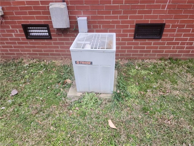 exterior details with central AC and brick siding