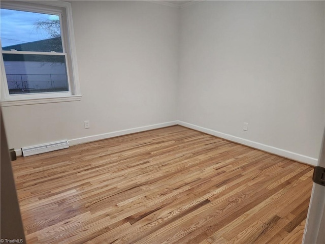 unfurnished room featuring light wood-style floors, visible vents, and baseboards