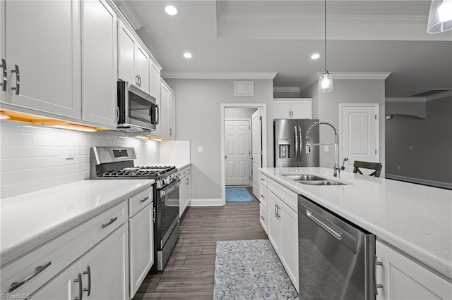 6624 Knob Creek Dr, Whitsett, NC 27377 - kitchen with stainless steel appliances, a sink, crown molding, recessed lighting, and light countertops