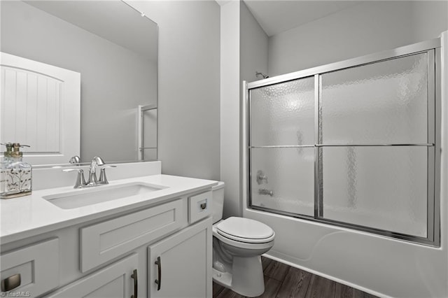 6624 Knob Creek Dr, Whitsett, NC 27377 - bathroom featuring vanity, wood finished floors, toilet, and shower / bath combination with glass door