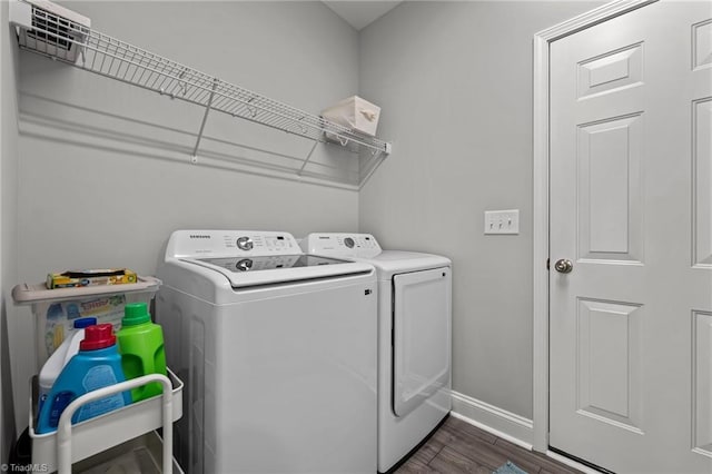 6624 Knob Creek Dr, Whitsett, NC 27377 - washroom featuring washing machine and dryer, baseboards, and dark wood-type flooring
