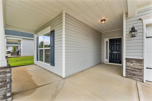 6624 Knob Creek Dr, Whitsett, NC 27377 - doorway to property with covered porch and stone siding