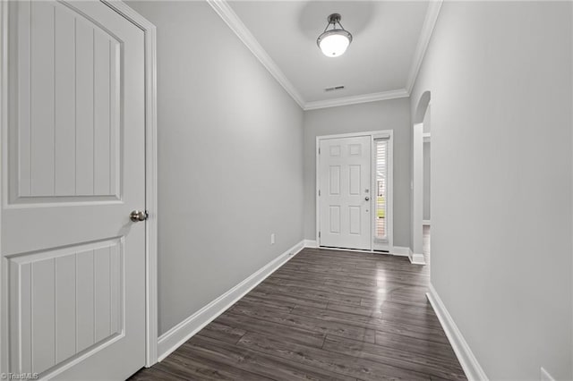 6624 Knob Creek Dr, Whitsett, NC 27377 - entryway with crown molding, arched walkways, dark wood-style flooring, and baseboards