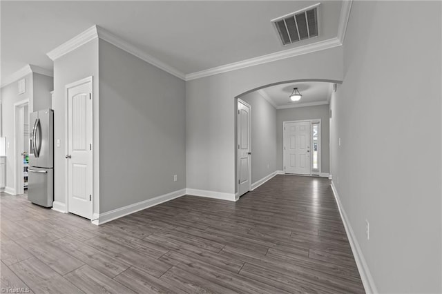 6624 Knob Creek Dr, Whitsett, NC 27377 - foyer featuring arched walkways, ornamental molding, dark wood-style floors, and baseboards